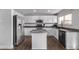 Modern kitchen with white cabinets, granite countertops, and island at 1365 Mulberry Ln, Highlands Ranch, CO 80129