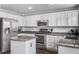 Modern kitchen features stainless steel appliances and granite countertops at 1365 Mulberry Ln, Highlands Ranch, CO 80129