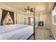 Main bedroom featuring a cozy fireplace, four-poster bed, and ensuite bathroom, offering a relaxing retreat at 17533 W 60Th Ln, Arvada, CO 80403