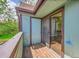 Balcony featuring wood flooring, storage, and sliding glass doors leading to the interior space at 12023 E Harvard Ave # 203, Aurora, CO 80014