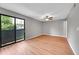 This bedroom has wood floors, neutral paint, and a sliding glass door to a balcony at 12023 E Harvard Ave # 203, Aurora, CO 80014