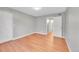 This bedroom features laminate flooring, gray paint, a closet and a view into the ensuite bathroom at 12023 E Harvard Ave # 203, Aurora, CO 80014