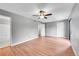 This bedroom features laminate flooring, gray paint and a ceiling fan at 12023 E Harvard Ave # 203, Aurora, CO 80014