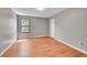 This bedroom has wood floors, neutral paint, and a window at 12023 E Harvard Ave # 203, Aurora, CO 80014