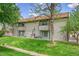 Apartment building showcasing manicured lawns, mature trees, and exterior architectural features at 12023 E Harvard Ave # 203, Aurora, CO 80014