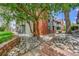 Building's exterior featuring brick accents, landscaping with decorative rocks, and a pedestrian walkway at 12023 E Harvard Ave # 203, Aurora, CO 80014