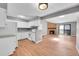 Open floor plan connecting the kitchen and living room, featuring wood floors and stone fireplace at 12023 E Harvard Ave # 203, Aurora, CO 80014