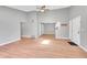 Bright living room with vaulted ceilings, skylight, wood floors, and a view of the adjacent kitchen at 12023 E Harvard Ave # 203, Aurora, CO 80014