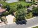 Aerial view of a single Gathering home with large driveway surrounded by mature trees and a green lawn at 3780 W 66Th Ave, Arvada, CO 80003