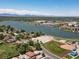 Aerial view showcasing community near lake, featuring cozy homes and outdoor baseball field with mountain backdrop at 3780 W 66Th Ave, Arvada, CO 80003