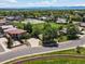 Aerial shot of residential homes and greenery surrounded by baseball field, parking lots, and tall trees at 3780 W 66Th Ave, Arvada, CO 80003