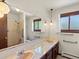 Bathroom with a double sink vanity, large mirror, and a shower-tub combination at 3780 W 66Th Ave, Arvada, CO 80003