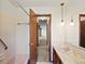 Bathroom featuring tile floors, a pink tub-shower combination, and an adjacent view into a hallway at 3780 W 66Th Ave, Arvada, CO 80003