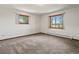 Bedroom with neutral carpet, two windows and baseboard heater at 3780 W 66Th Ave, Arvada, CO 80003