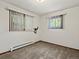 A well-lit bedroom features two windows with blinds and a wall-mounted bracket at 3780 W 66Th Ave, Arvada, CO 80003