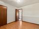 Bedroom showing laminate flooring, closet and access to hallway at 3780 W 66Th Ave, Arvada, CO 80003
