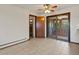 Dining room with ceiling fan, beige tile flooring, access to sunroom and closet at 3780 W 66Th Ave, Arvada, CO 80003