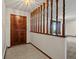 Welcoming foyer with tile flooring, wooden half-wall, and dark wood front door at 3780 W 66Th Ave, Arvada, CO 80003