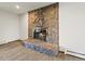 Living room showcasing a stone fireplace with a glass door and a stone hearth at 3780 W 66Th Ave, Arvada, CO 80003