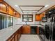 Updated kitchen with granite countertops, wood cabinets, and sleek black appliances at 3780 W 66Th Ave, Arvada, CO 80003