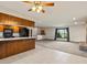 Open floor plan showing living room and kitchen with breakfast bar and fireplace at 3780 W 66Th Ave, Arvada, CO 80003