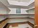 Walk-in pantry with wood trim shelves and white walls at 3780 W 66Th Ave, Arvada, CO 80003