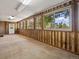 Well-lit sunroom with wood-paneled walls and many windows overlooking a landscaped exterior at 3780 W 66Th Ave, Arvada, CO 80003