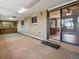 Large sunroom with brick and wood-paneled walls, featuring large windows and a sliding glass door at 3780 W 66Th Ave, Arvada, CO 80003