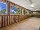 Bright sunroom with wood-paneled walls and multiple windows, offering abundant natural light at 3780 W 66Th Ave, Arvada, CO 80003