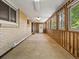 Bright sunroom with brick and wood paneling, large windows, and access to the outdoors at 3780 W 66Th Ave, Arvada, CO 80003