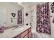 Bathroom featuring granite counters, a shower-tub combo and floral accents at 6268 Pike Ct # D, Arvada, CO 80403