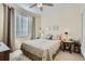 Cozy bedroom featuring a comfortable bed, soft lighting, and window that provides natural light at 6268 Pike Ct # D, Arvada, CO 80403