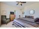 Comfortable bedroom features a window, ceiling fan, dresser, and ensuite bathroom and hallway access at 6268 Pike Ct # D, Arvada, CO 80403