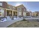 Attractive exterior view of two-story townhomes, featuring brick accents and a well-kept landscape at 6268 Pike Ct # D, Arvada, CO 80403