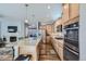 Spacious kitchen with stainless steel appliances, island with seating, and open view to the living room at 6268 Pike Ct # D, Arvada, CO 80403