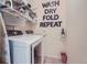 Modern laundry room equipped with a front-loading washer and dryer and ample shelving for storage at 6268 Pike Ct # D, Arvada, CO 80403