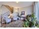 Bright living room featuring a staircase, hardwood floors, large windows, and comfortable seating at 6268 Pike Ct # D, Arvada, CO 80403