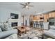 Open floor plan boasts a kitchen with breakfast bar and a living room with fireplace and TV at 6268 Pike Ct # D, Arvada, CO 80403