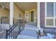 Inviting covered front porch with a cozy seating area and wrought iron railing, offers a relaxing outdoor space at 6268 Pike Ct # D, Arvada, CO 80403