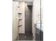Contemporary walk-in shower with tiled walls, corner shelves, and a glass door at 3515 S Ogden St, Englewood, CO 80113