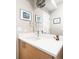 Sleek bathroom vanity with modern faucet, artwork, and decorative accents at 3515 S Ogden St, Englewood, CO 80113