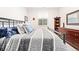 Relaxing bedroom with a gray and white striped comforter, decorative pillows, and a wooden dresser at 3515 S Ogden St, Englewood, CO 80113