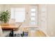 Dining area featuring wood table, four upholstered chairs, and modern decor with ample natural light at 3515 S Ogden St, Englewood, CO 80113