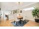 Bright dining room featuring wood table, chairs, pendant lighting, and seamless flow into kitchen at 3515 S Ogden St, Englewood, CO 80113