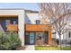 Modern home showcasing a blue front door, gray brick, and light-colored siding with wood accents at 3515 S Ogden St, Englewood, CO 80113