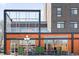 Exterior of a commercial building featuring large windows, street side dining, and a modern design at 3515 S Ogden St, Englewood, CO 80113