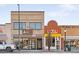 Exterior view of commercial building with a brick facade featuring multiple business storefronts at 3515 S Ogden St, Englewood, CO 80113