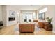 Living area with a fireplace, modern furniture, sliding glass doors, and exposed brick accent wall at 3515 S Ogden St, Englewood, CO 80113