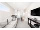 Comfortable entertainment space with a kitchenette, couch, and a mounted television at 3515 S Ogden St, Englewood, CO 80113