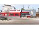 Exterior view of a 'Cochino Taco' restaurant featuring a red awning and unique pig art at 3515 S Ogden St, Englewood, CO 80113